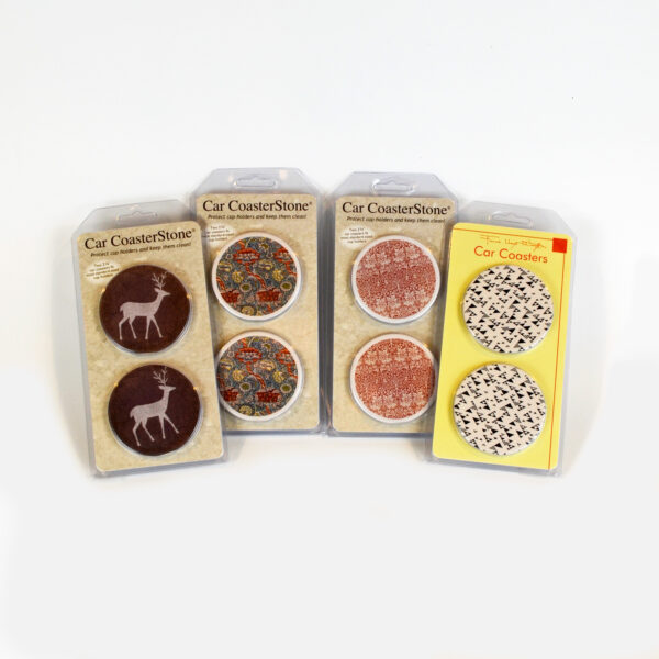 This image shows the four different car coasters we have in stock: deer, a blue and a red William Morris pattern, and a black and white Frank Lloyd Wright pattern.