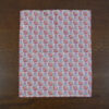 This is the orange tea towel in the Leaf and Berry pattern