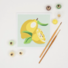 This image shows the paint brush and paints included with the Lemon Paint-by-Number Kit.