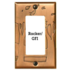 This image shows a rocker/GFI style copper light switch plate by James Matteson in the landscape design. A single large tree are to the left of the left toggle switch. One large tree can be found on the left and right side of the outlet cover.