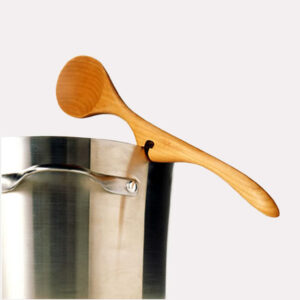 This image shows the Lazy Spoon® resting on a metal pot.