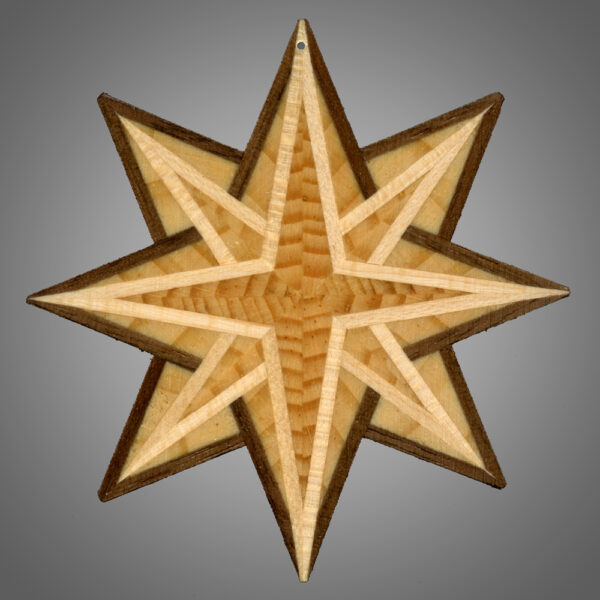 This image shows a translucent 8 point star created by Kurt Meyer. Each star is different and this one has a blonde boarder around the 4 central points of the star and a darker brown wood around the other 4 points.