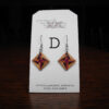 This image shows a close up of Kurt Meyer's earring labeled "D".