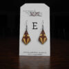 This image shows a close up of Kurt Meyer's earring labeled "E".