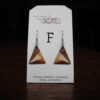This image shows a close up of Kurt Meyer's earring labeled "F".