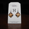 This image shows a close up of Kurt Meyer's earring labeled "H".