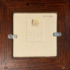 This image shows the back of this framed tile and how it can be hung.