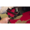 This image shows the process of cutting a leather shape from a larger hide.