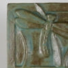 This detail shows how the glaze pools in the recessed areas of the plaque.