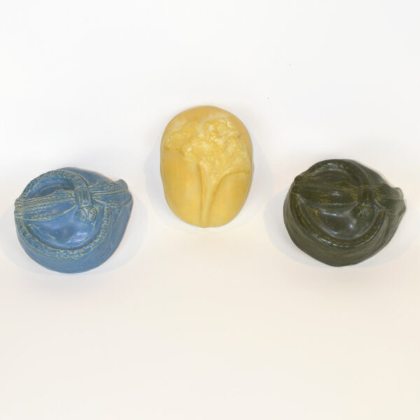 This image shows the variety of paperweights we offer. Dragonflies in blue and forest green, and a yellow gingko paperweight.