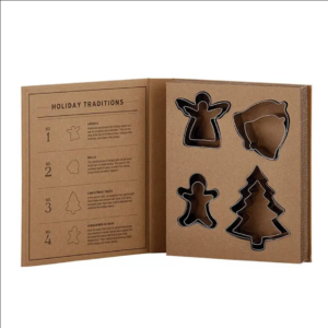 This image shows the contents of the Holiday Cookie Cutter Book Box in the box.