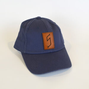 Blue baseball cap with a brown leatherette patch with the "S" found on the staircase in the Log Cabin