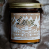 This image shows the candle Lodge. It is staged in a fuzzy blanket.