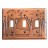 This image shows a triple switch copper light switch plate by James Matteson in the landscape design. Three small trees are to the left of the first switch. A single large tree is featured on either side of the middle switch and a cluster of trees can be found to the right of the switch furthest to the right.