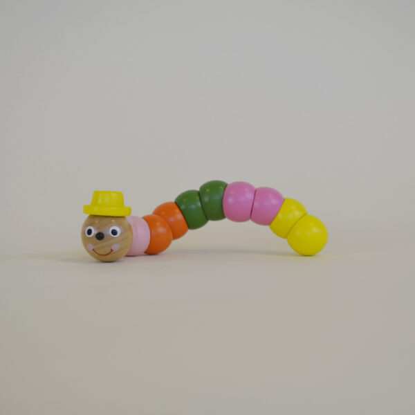 Wooden worm with pink, orange, green and yellow segmented body parts, wearing a yellow top hat.