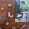 This image shows a detail of the squirel and maple leaf whimsies in the puzzle featuring Yoshiko Yamamoto's print.