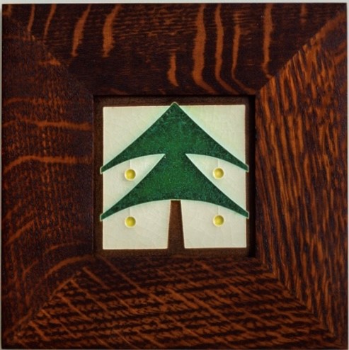 This image shows a ceramic tile of an evergreen tree adorn with 4 yellow circular ornaments. It is displayed in a square quartersawn oak frame.